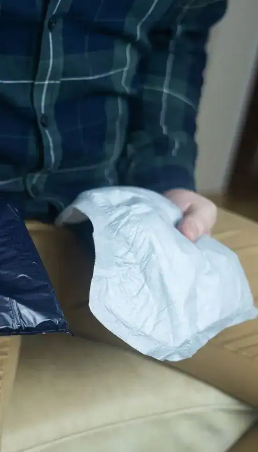 Image of man holding incontinence pads as part of overactive bladder treatment Leicester