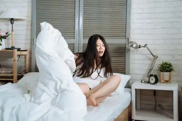 Image of woman getting up because of nighttime leaks Leicester